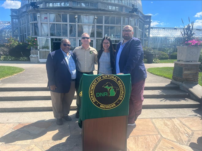 Bishop Tony Russell of Detroit Community Solutions, Assistant Secretary for Fish and Wildlife and Parks Shannon Estenoz and Brad Dick, Detroit's Deputy Director for General Services Department speak at Belle Isle about national funding for outdoor spaces.
