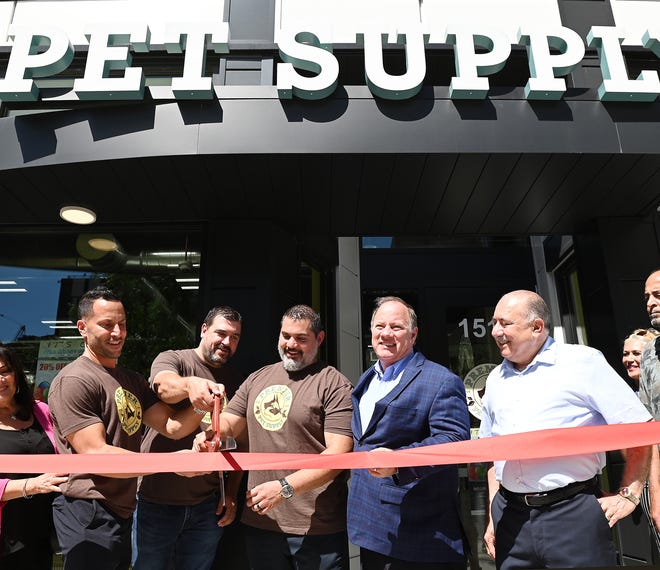 L-r, Co-owners, Mike Palmer, Brandon Thorne, Jeff Nagarah, Mayor Mike Duggan and Jamal Abro, cut the ribbon to celebrate the opening of Premier Pet Supply store in downtown Detroit. July 29, 2022, Detroit, MI.