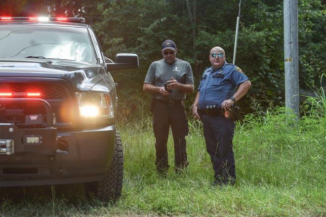 Deputy State Fire Marshall Pete Adcock (left) is on the scene alongside Deputy Sheriff Lt. Cline Wyman outside of an oil well storage facility after an oil tank explosion was reported in Flora, Miss., Friday, July 29, 2022. Six people were seriously injured, two of whom were airlifted to local hospitals.
