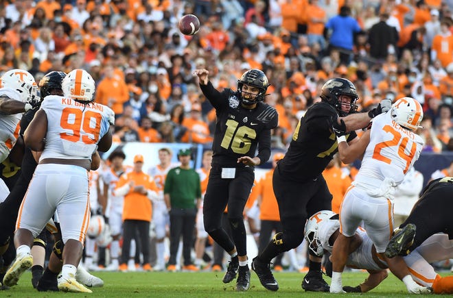 Dec 30, 2021; Nashville, TN, USA; Purdue Boilermakers quarterback Aidan O'Connell (16) passes the ball during the first half against the Tennessee Volunteers in the 2021 Music City Bowl at Nissan Stadium. Mandatory Credit: Christopher Hanewinckel-USA TODAY Sports