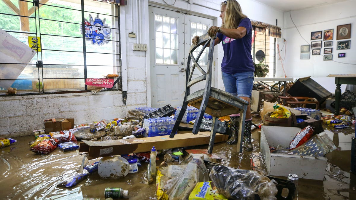 "I've never seen it this bad," said Campbell's Grocery employee Kella Sloan, as she helps clean up the muddy mess that Thursday's flood left in Garrett, Ky. Water reached about six feet high in the tiny downtown area.  July 29, 2022