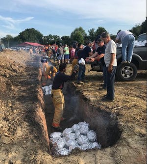 The Shiloh Firemen's Ox Roast starts with placing four pickup truck loads of 20-pound beef roasts into a pit where they will cook for at least 12 hours. The festival is this weekend in Shiloh.