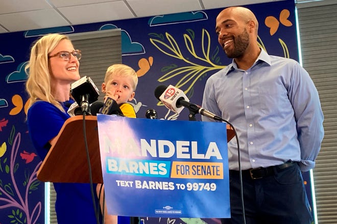 Wisconsin Treasurer Sarah Godlewski, holding her son Hartley, throws her support to Lt. Gov. Mandela Barnes after dropping out of the Democratic primary for U.S. Senate less than two weeks before the primary on Friday in Fitchburg.