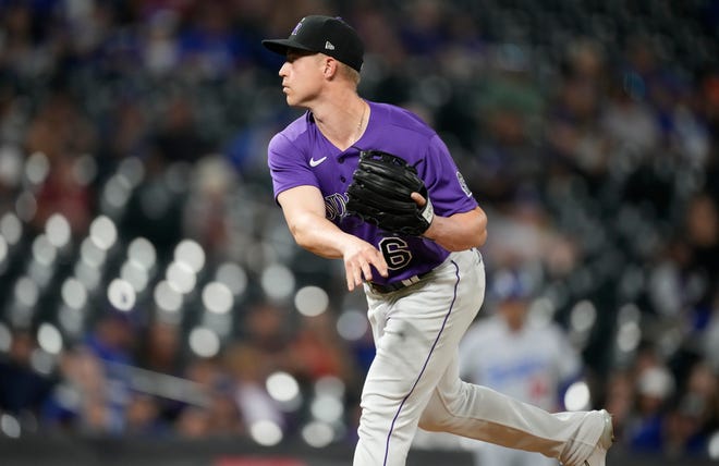 Colorado Rockies catcher Brian Serven pitches against the Los Angeles Dodgers during the ninth inning of a baseball game Thursday, July 28, 2022, in Denver. (AP Photo/David Zalubowski)