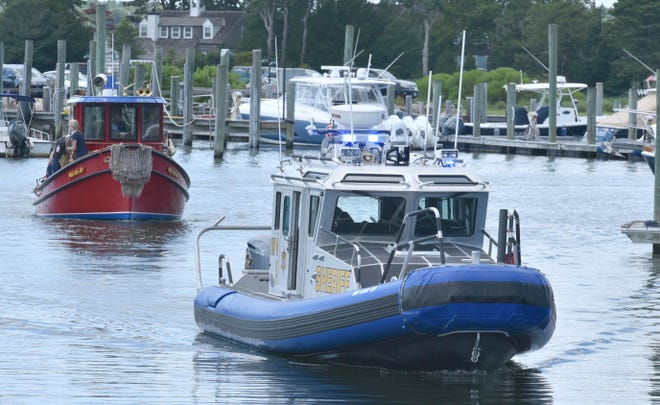 A Barnstable County Sheriff's Department boat with lights and sirens blaring escorted a tugboat bringing bride Elizabeth Akeley to her wedding at the Nauticus Marina in Osterville on July 30 when  she married George Regan.