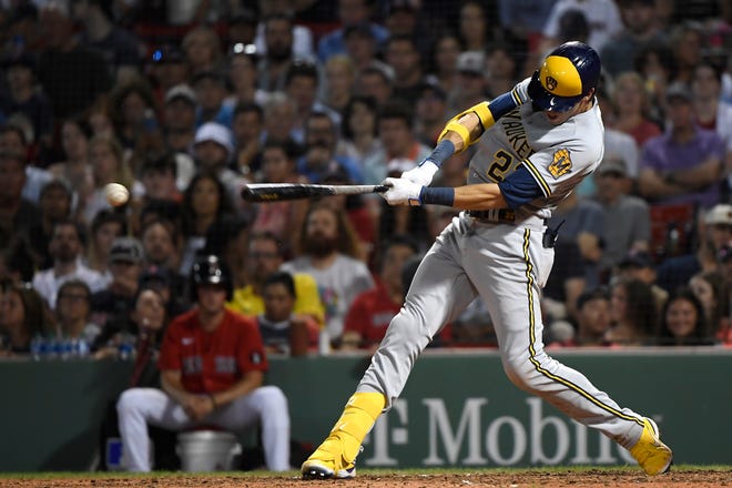 Brewers leftfielder Christian Yelich delivers an RBI single against the Red Sox during the seventh inning Friday night.