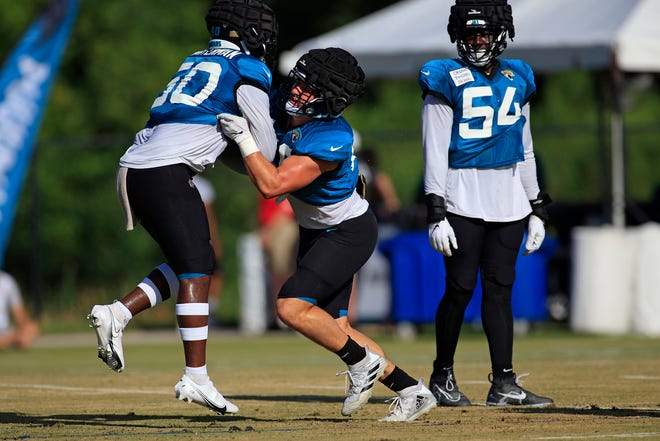 Jaguars inside linebackers Shaq Quarterman (left) and Chad Muma (right) practice tackling techniques during training camp on July 31 at the Episcopal School's Knight Campus.