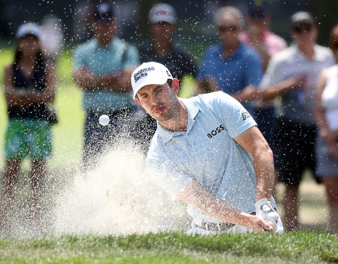 Patrick Cantlay hits out of the bunker on hole No. 4 during the final round of the Rocket Mortgage Classic at the Detroit Golf Club Sunday, July 31, 2022.