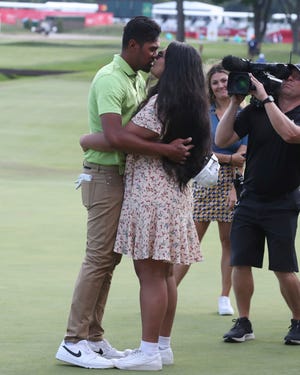 Tony Finau and his wife Alayna celebrate after winning the Rocket Mortgage Classic at the Detroit Golf Club Sunday, July 31, 2022.