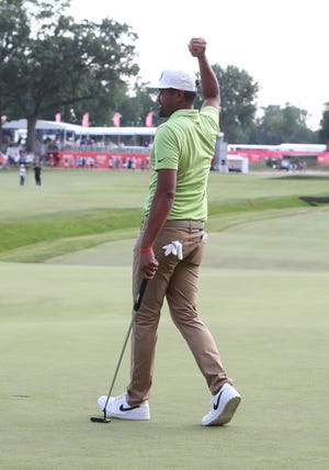 Tony Finau celebrates winning the Rocket Mortgage Classic at the Detroit Golf Club Sunday, July 31, 2022.