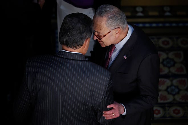 Sen. Joe Manchin, left, talks with Senate Majority Leader Charles Schumer in the Eisenhower Executive Office Building on March 15, 2022, in Washington, D.C. (Chip Somodevilla/Getty Images/TNS)