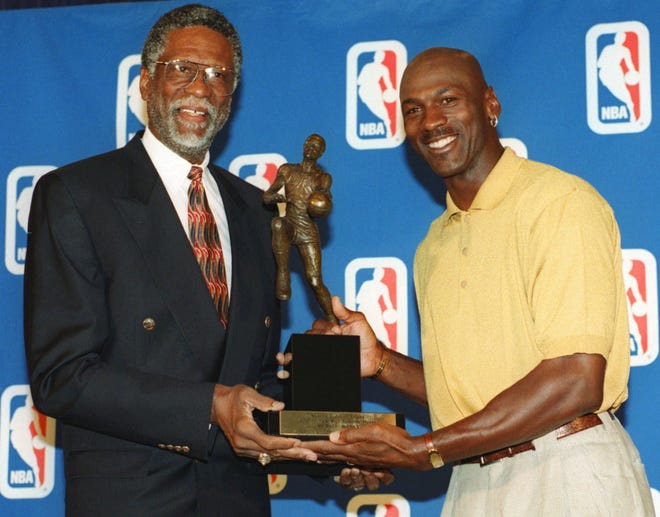 Michael Jordan holds his fifth NBA MVP award with Bill Russell in 1998.