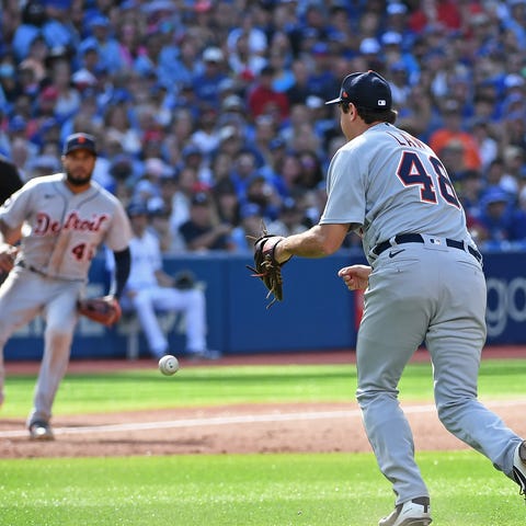 Detroit Tigers pitcher Derek Law (48) drops a grou