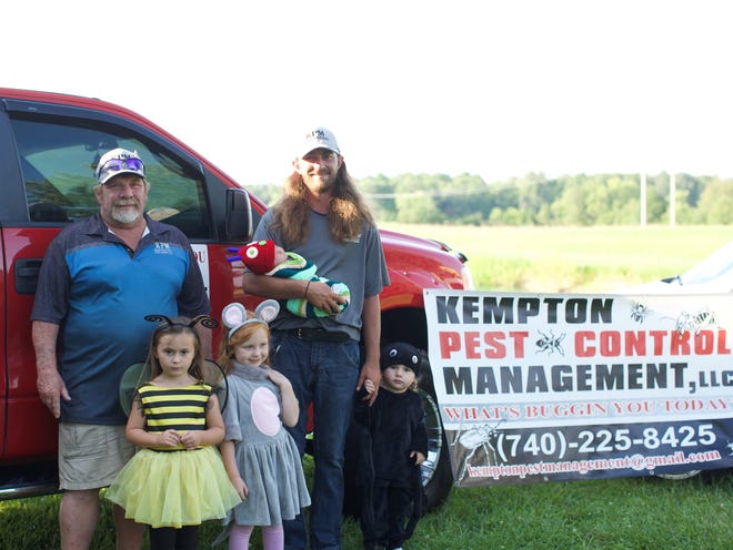 Father (Brad Kempton, left) and son (Cody Kempton, right) run Kempton Pest Management. They are shown posing with little "pests" Nadia (bee), Melody (mouse), Lianna (spider) and Oakley (caterpillar).