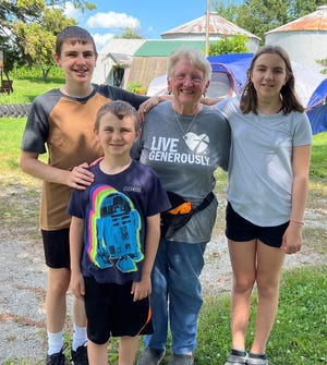 Susan is joined by her grandchildren Eli, from left,  Wyatt, on the first day of camping on the farm.