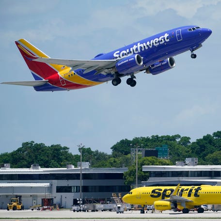 A Southwest Airlines Boeing 737, passes a Spirit Airlines Airbus A320 as it takes off, Thursday, July 7, 2022, at the Fort Lauderdale-Hollywood International Airport in Fort Lauderdale, Fla. (AP Photo/Wilfredo Lee) ORG XMIT: FLWL215