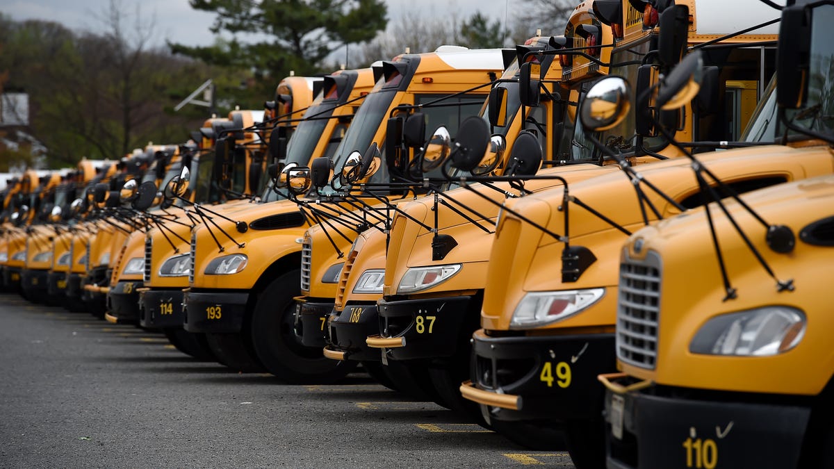 About 100 school buses are parked at the Arlington County Bus Depot,  in response to the novel coronavirus, COVID-19 outbreak on March 31, 2020 in Arlington, Virginia. - Forty-seven states and the District of Columbia have decided to close schools in response to the coronavirus pandemic, affecting nearly 55 million students and seven US states have closed school for the remainder of the year, as the coronavirus outbreak continues to spread across the country.   (Photo by Olivier DOULIERY / AFP) (Photo by OLIVIER DOULIERY/AFP via Getty Images)