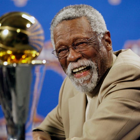 NBA great Bill Russell reacts at a news conference