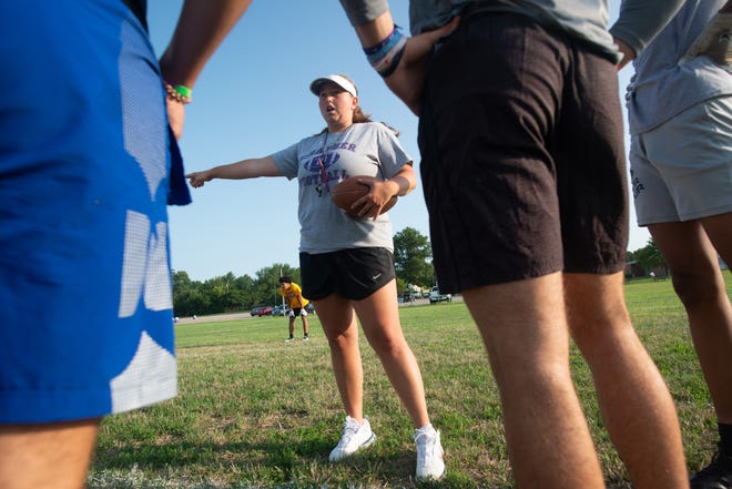 Sara Burgess, Topeka West's new assistant football coach, huddles to review a play during practice Tuesday morning at the high school. Burgess, a special education teacher at Topek High, is currently the only female varsity football coach out of the 10 Topeka-area schools.