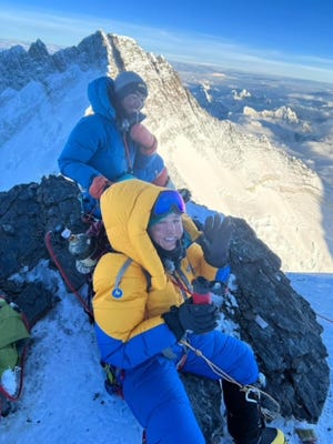Dr. Qaisra Saeed and her Sherpa, G. Lakpa, on the balcony below the summit ridge.