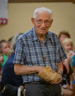 Tony Picciuto, wearing one of his handmade crosses, brought a bag full of crosses to give to children attending Vacation Bible School at Solomon Lutheran Church on July 27. As of his birthday on July 28, Picciuto had made 29,300 crosses.