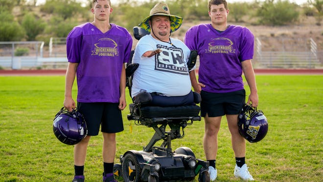 Arizona football coach, born without arms and legs, sees no obstacles