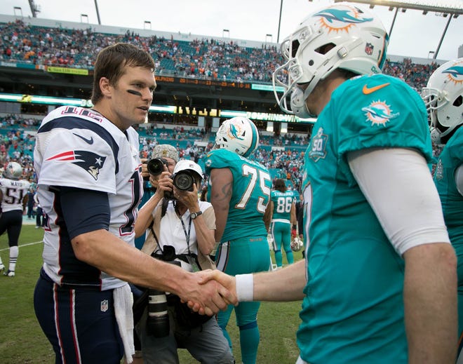 New England Patriots quarterback Tom Brady (12) shakes hands with Miami Dolphins quarterback Ryan Tannehill (17) at Sun Life Stadium in Miami Gardens, Florida on January 3, 2016.