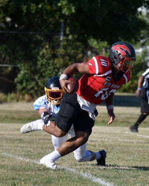 Southeast Michigan Red Storm quarterback Mike Tucker carries the ball during a game earlier this season. The Red Storm will host the first playoff game in team history at 6:30 p.m. Saturday at Navarre Field.