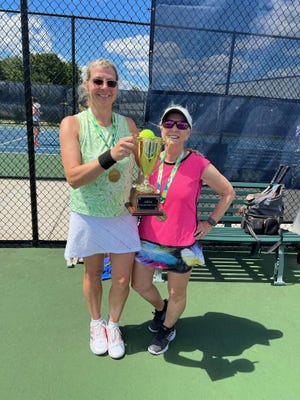 The inaugural 'Moxie' tournament champions, Eve Elden and Julie Regan, pose with their trophy.