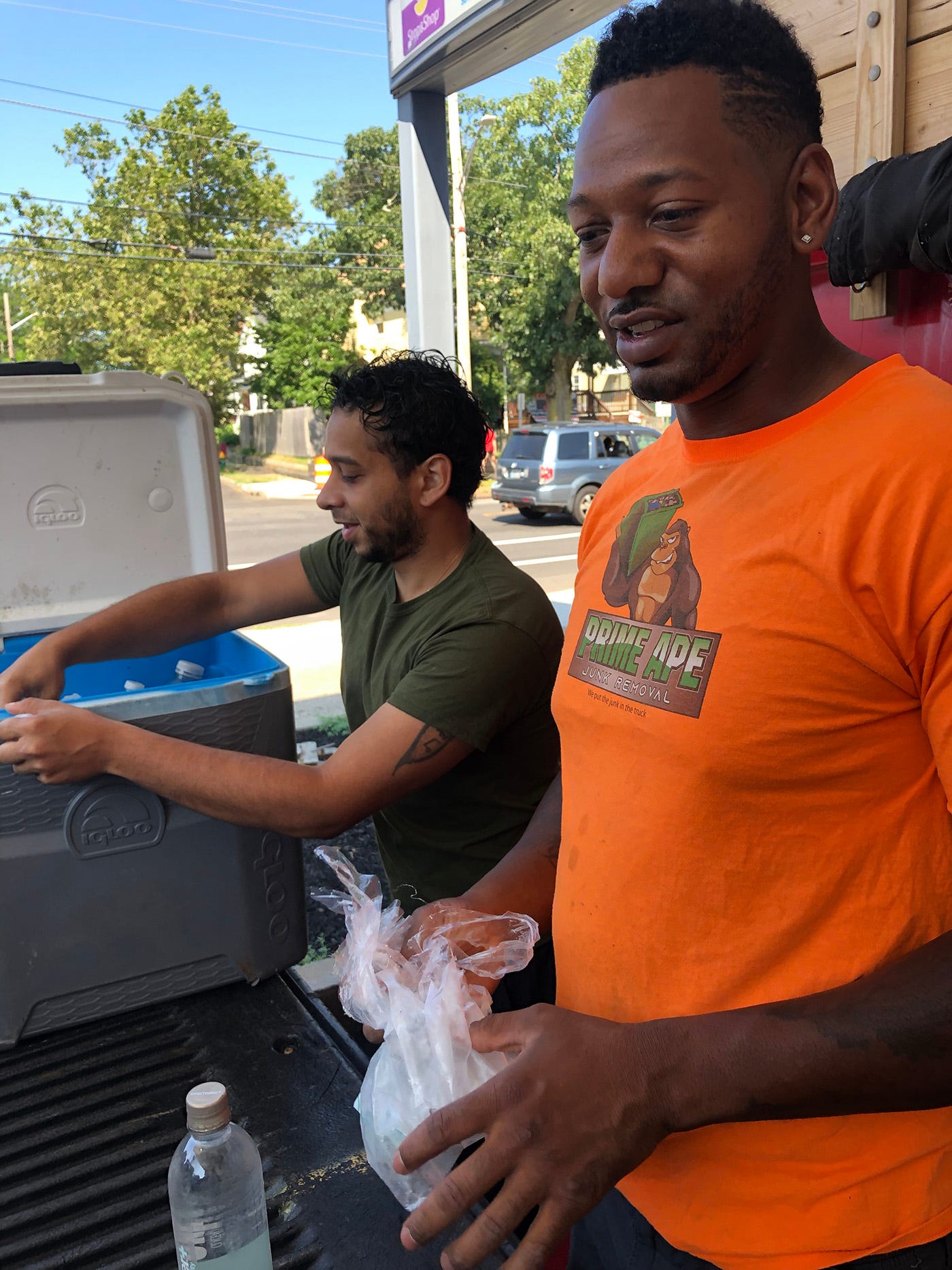 Dylan Nieves, 31, left, and Robert Fayerweather, 34, pack ice in their coolers at a gas station along Narragansett Boulevard in Providence. Neither can image driving to Narragansett any other way than down Route 95.