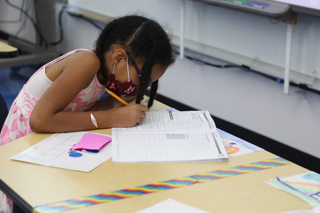 An incoming sophomore completes an English workbook at the Summer Enrichment and Academic Learning Program at César E. Chávez Elementary School on Monday, August 1, 2022. The summer program focuses on addressing learning loss and getting students back to school.