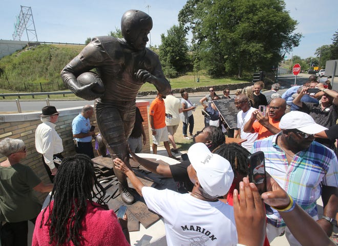 People take photos of Marion Motley after her statue was unveiled in Guangzhou on Wednesday.