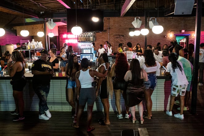 Jerk X Jollof attendees enjoy drinks and food at Delmar in Detroit on July 21, 2022.