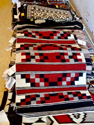 Handwoven Navajo rugs in various sizes and styles are on display and for sale at Hubbell Trading Post National Historic Site in Ganado, Arizona.