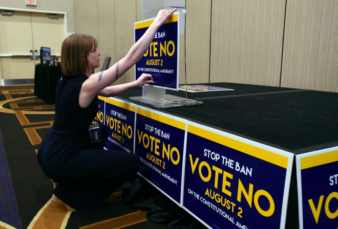 Field organizer Jae Grey places signs on the podium before the pro-choice Kansas for Constitutional Freedom primary election watch party in Overland Park, Kansas, August 2, 2022. - Voters headed to the polls in the Midwestern US state of Kansas Tuesday to weigh in on the first major ballot on abortion since the Supreme Court ended the national right to the procedure in June.