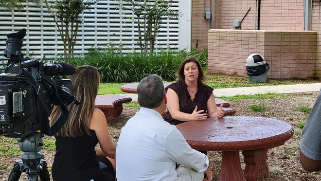 Stephanie Yocum, president of the Polk Education Association, chats with media outside the school district offices ahead of Superintendent Frederick Heid's news conference, Aug. 4, 2022. Yocum said the teacher shortage is more like an exodus.