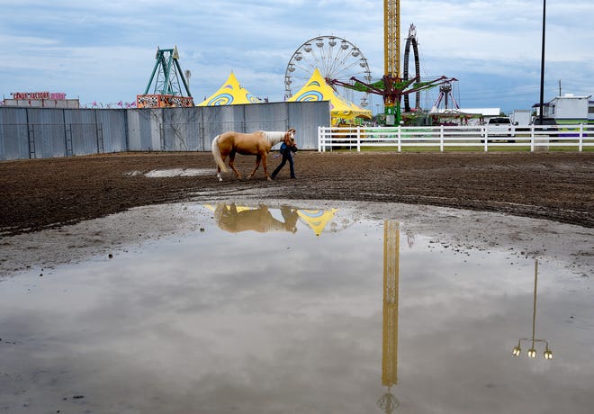 Heavy rain and extreme heat canceled Wednesday events and delayed the competition as riders stayed clear of large mud puddles in the practice area of the horse arena at the Monroe County Fair.