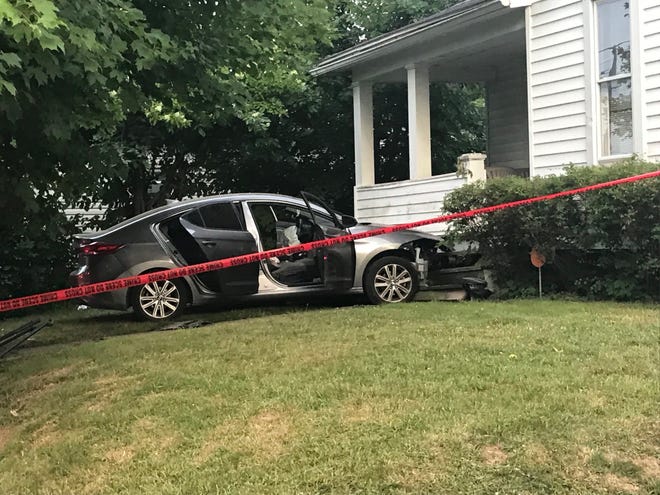 A car crashed into a house Wednesday night on Ford Street. Mansfield police are investigating at least three people shot.