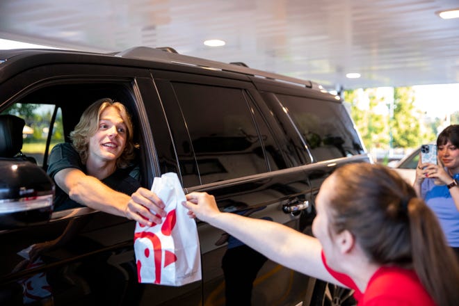 Blake Altman and his friends were the first customers to come through the drive-thru after the official opening of Chick-fil-A on Thursday in Keizer.