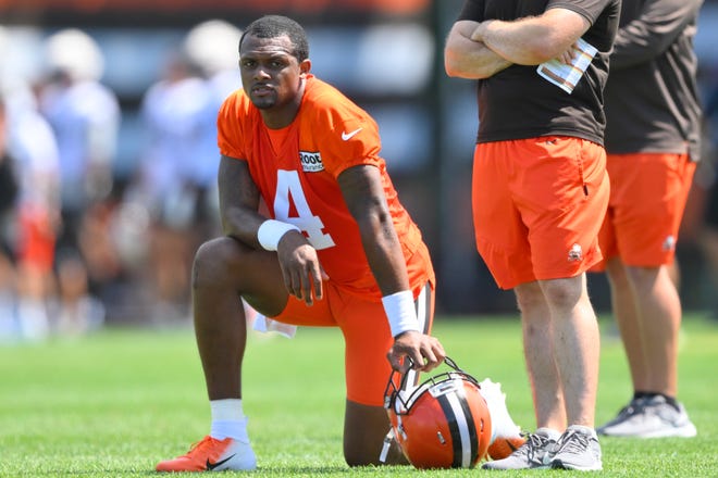 Cleveland Browns quarterback Deshaun Watson kneels on the field during the NFL football team's training camp, Wednesday, Aug. 3, 2022, in Berea, Ohio.