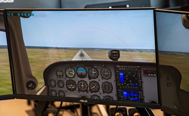 Mustang High School student Antonin Stoddard takes part in an aviation lesson Aug. 5, 2022, while using a flight simulator in the Mustang High School's Aviation Lab.