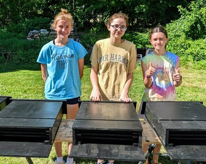 Showing off their bat houses are (from left) Maren Paquette, Alyssa Trombley and Hannah Rauscher; not shown, Tea Morini.