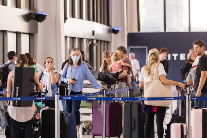 Travelers line up to check in for United Airlines flights at Newark Liberty International Airport on July 1, 2022.