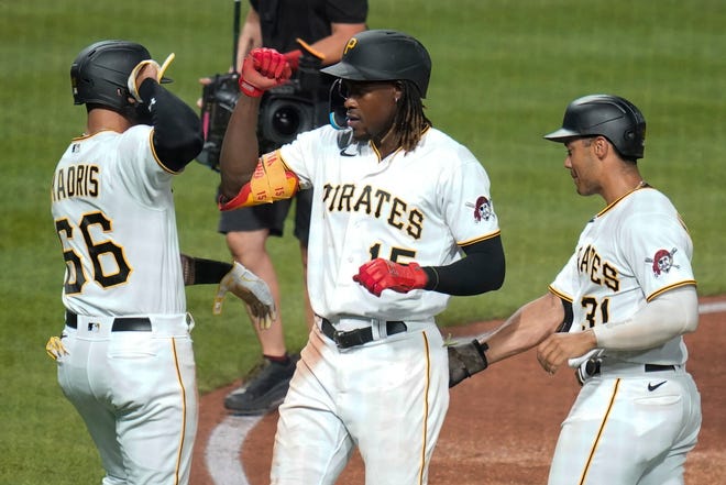 Pittsburgh Pirates' Oneil Cruz (15) is greeted by Bligh Madris (66) and Cal Mitchell (31) after driving them in with a three-run home run against the Milwaukee Brewers during the sixth inning of a baseball game Tuesday, Aug. 2, 2022, in Pittsburgh. (AP Photo/Keith Srakocic)