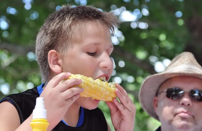 A corn eating contest takes place at Rossville's Tall Corn Festival.