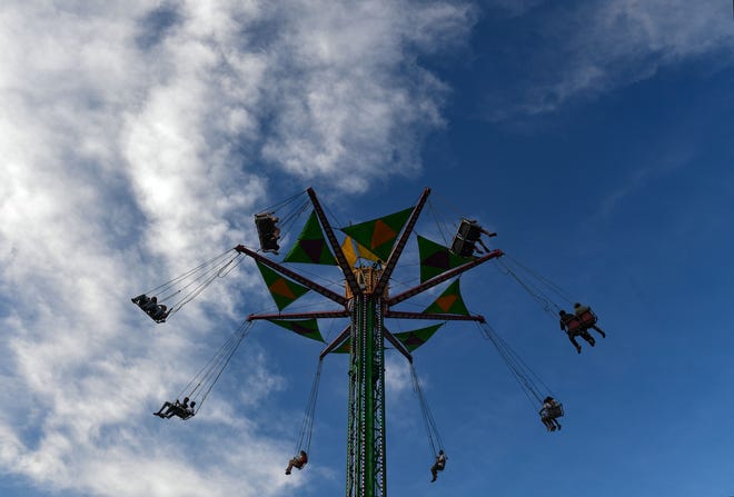 Visitors ride the chair swings into the air at the Sioux Empire Fair on Friday, August 5, 2022, at the W.H. Lyon Fairgrounds in Sioux Falls.