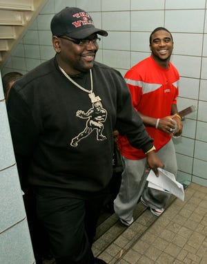 Former Ohio State quarterback Troy Smith, right, watches Glenville High coach Ted Ginn Sr. in 2006.