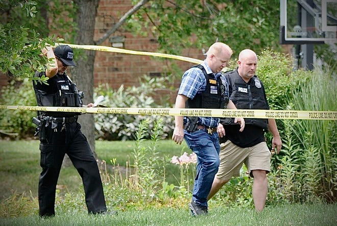 Police investigate a shooting Friday, Aug. 5, 2022, in Butler Township, Ohio.  Authorities say four people were shot to death in the Ohio suburb and a man considered armed and dangerous is being sought.