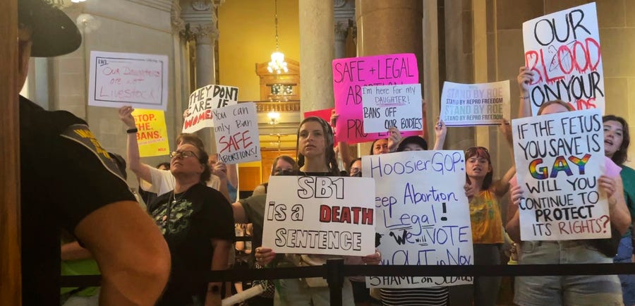 Abortion-rights protesters fill the Indiana Statehouse corridors outside legislative chambers as lawmakers vote to concur on a near-total abortion ban.