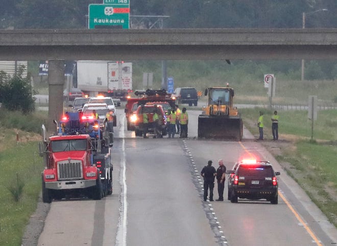 Officials work at the scene of a dump truck crash on Aug. 3 in Little Chute. The truck crashed into the bottom of the Rosehill Road/County CC overpass on southbound Interstate 41.